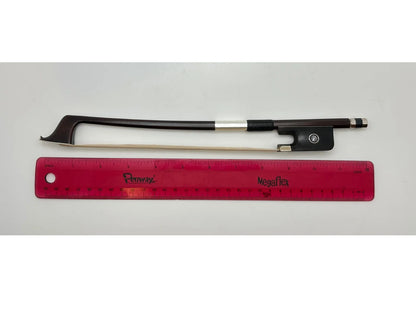 Violin bow and red ruler on a gray background