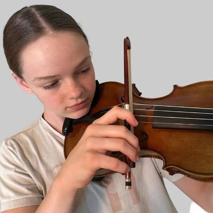 Young girl playing the violin on a white background